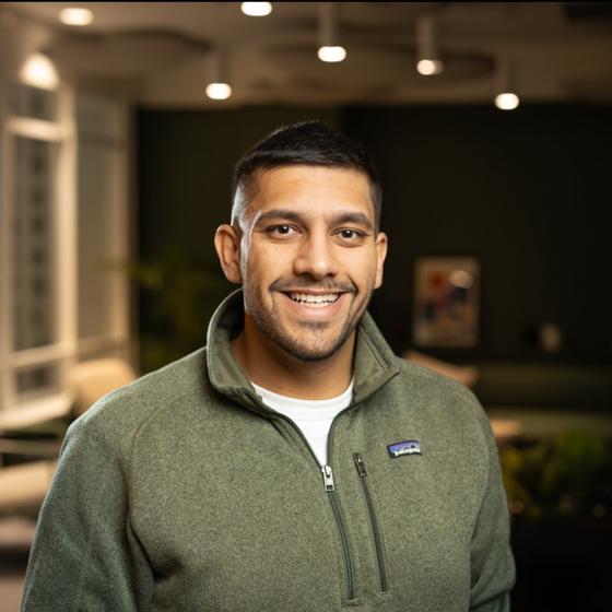 Adam, smiling in a green fleece